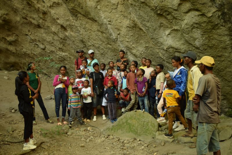 Students gather around a park guide to learn more about Anja Community Reserve