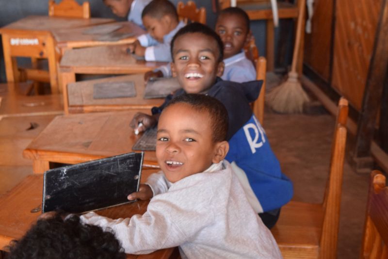 Two preschool students smile for the camera.