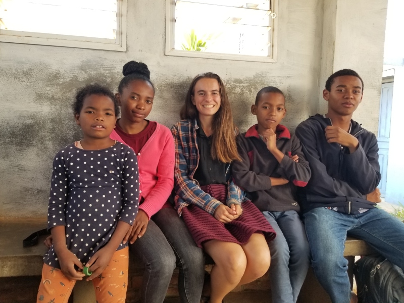 Five people, including four students, sitting in a waiting area at the dental office.